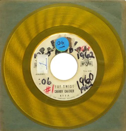A yellow record with some blue stickers on it